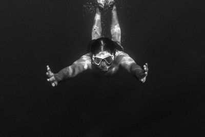 Portrait of shirtless woman in swimming pool