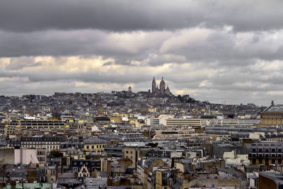 High angle view of city against cloudy sky