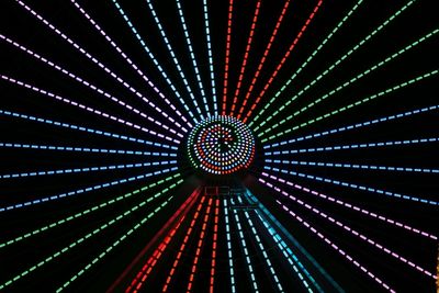 Low angle view of illuminated ferris wheel at night