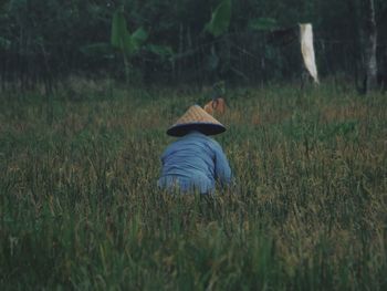 Rear view of man on field