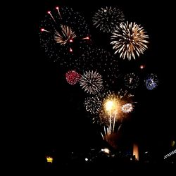 Low angle view of firework display at night