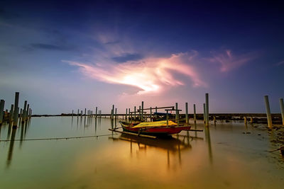 Boats in marina at sunset