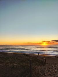 Scenic view of sea against clear sky during sunset