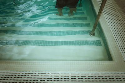 High angle view of person standing in swimming pool