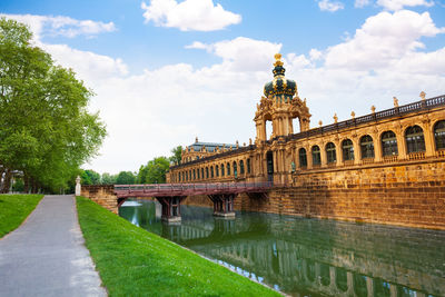 View of canal against cloudy sky