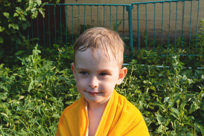 Wet and cheerful child in a towel. boy look away. summer is a time of pleasure and fun