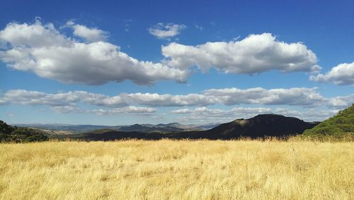 View of countryside landscape against cloudy sky