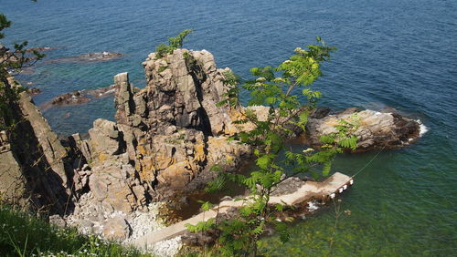 High angle view of rocks by sea