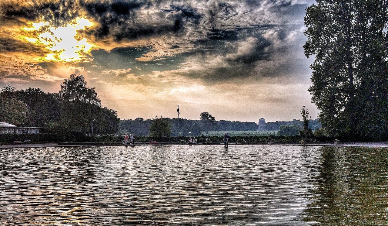 water, sky, waterfront, tree, cloud - sky, river, rippled, reflection, lake, nature, scenics, tranquility, silhouette, tranquil scene, beauty in nature, sunset, cloudy, building exterior, built structure, weather