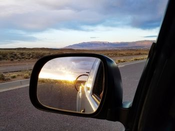 Reflection of road on side-view mirror of car
