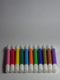 Close-up of colored pencils on white table