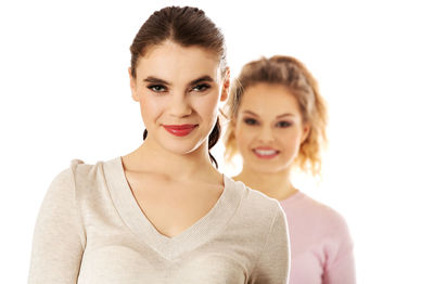 Portrait of a smiling young woman over white background
