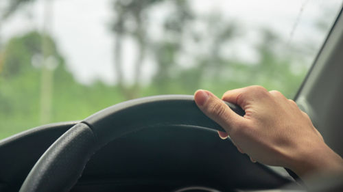 Cropped image of person hand car