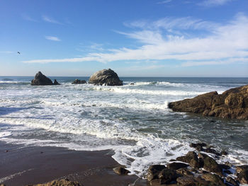 Scenic view of sea against sky on sunny day