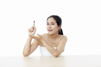 Portrait of a beautiful young woman over white background