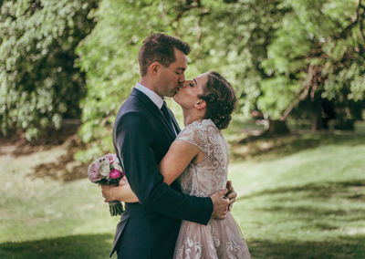 Full length of a couple kissing flower
