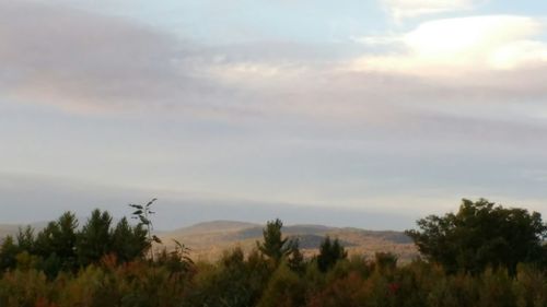 Scenic view of mountains against cloudy sky