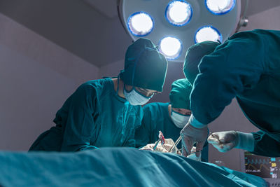 The surgeon team is working in the operating room. the surgeon is saving the patient's life.