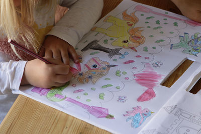 High angle view of woman hand on table