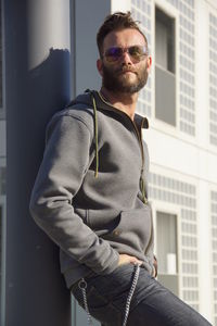 Young man standing by building