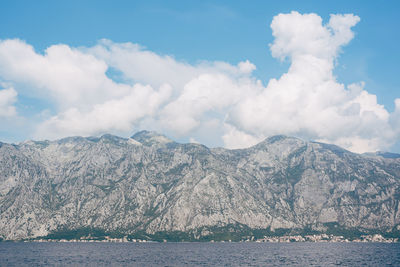 Scenic view of mountains against cloudy sky