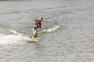Man kite boarding in river