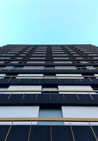 Low angle view of office building against clear blue sky