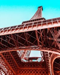 Low angle view of the eiffel tower, rendered in real and orange shades.