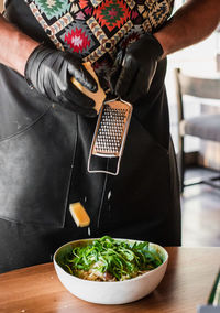 Midsection of man preparing food