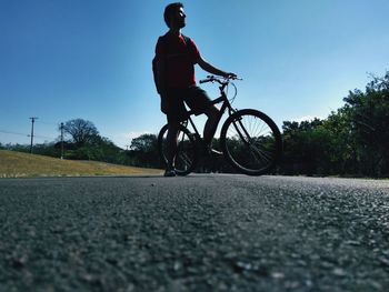 Man riding bicycle on road