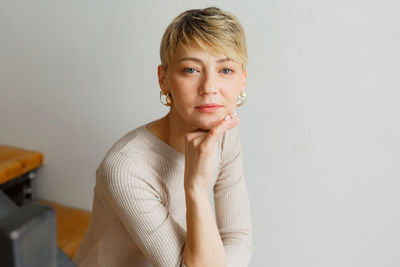 Portrait of young woman against white background