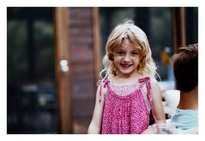 Portrait of smiling girl standing outdoors