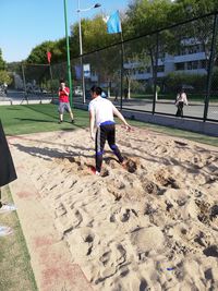 People playing soccer on sand