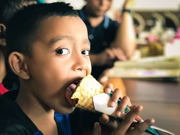 Close-up portrait of boy eating ice cream