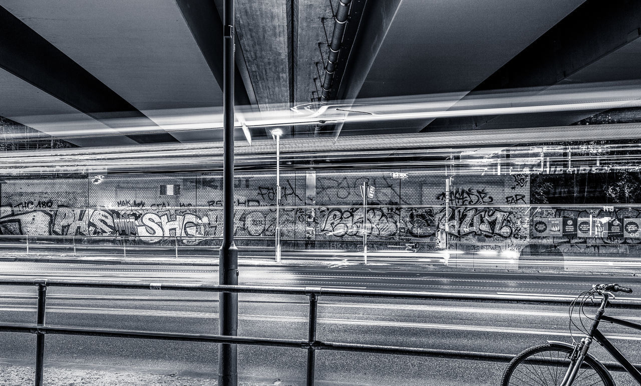 BLURRED MOTION OF TRAIN AT ILLUMINATED RAILROAD STATION