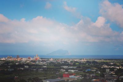 High angle view of townscape by sea against sky