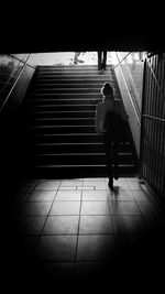 Full length of woman standing on railing