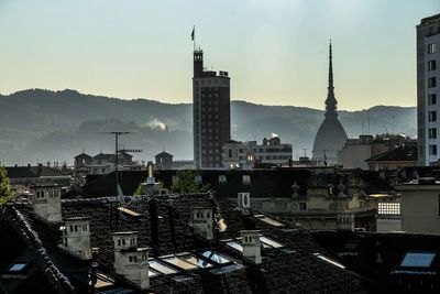 View of cityscape against cloudy sky