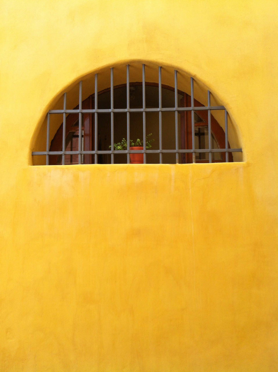 architecture, built structure, building exterior, yellow, window, wall - building feature, building, indoors, pattern, arch, no people, wall, low angle view, orange color, closed, day, modern, house, brick wall