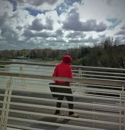 Full length rear view of woman standing against sky