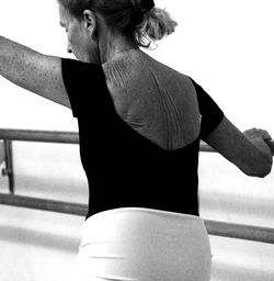 Woman looking away while standing on railing