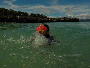 Portrait of girl swimming in sea