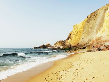 Scenic view of beach against clear sky
