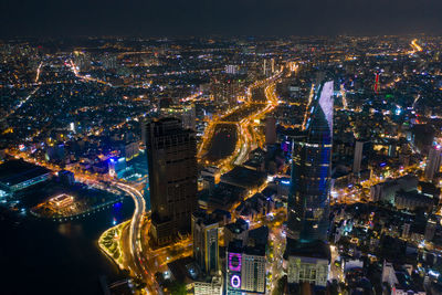 High angle view of city lit up at night