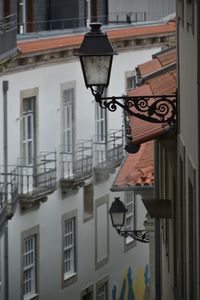 Low angle view of street light against building