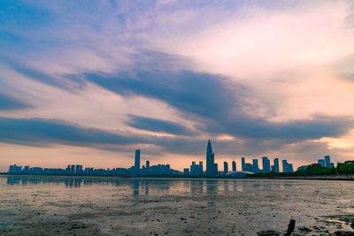 View of buildings against cloudy sky during sunset