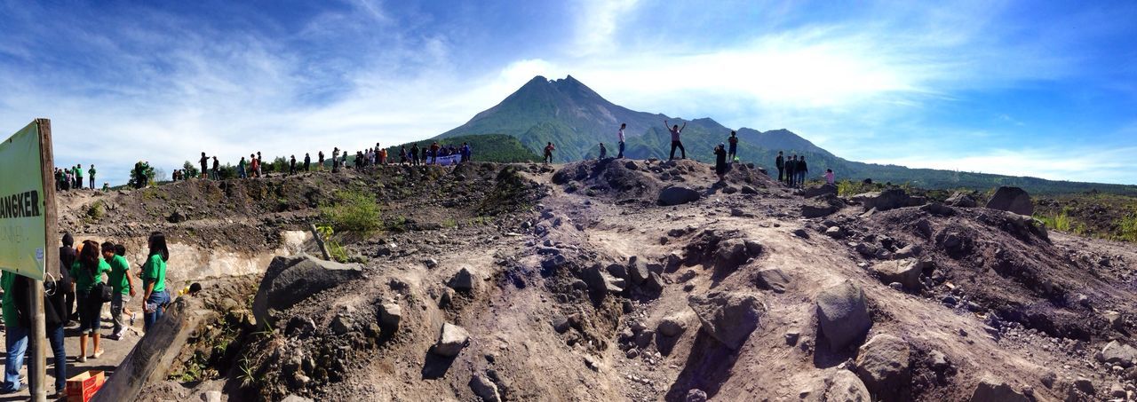 sky, cloud - sky, mountain, cloud, built structure, men, person, panoramic, sunlight, architecture, incidental people, sand, rock - object, nature, day, cloudy, lifestyles, travel destinations, travel