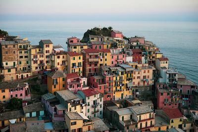 High angle view of townscape by sea against sky