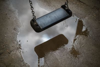 Reflection of swing on puddle
