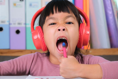 Portrait of boy eating food at home